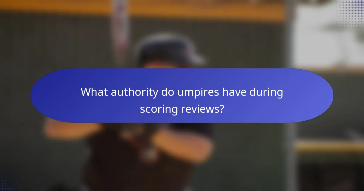 What authority do umpires have during scoring reviews?